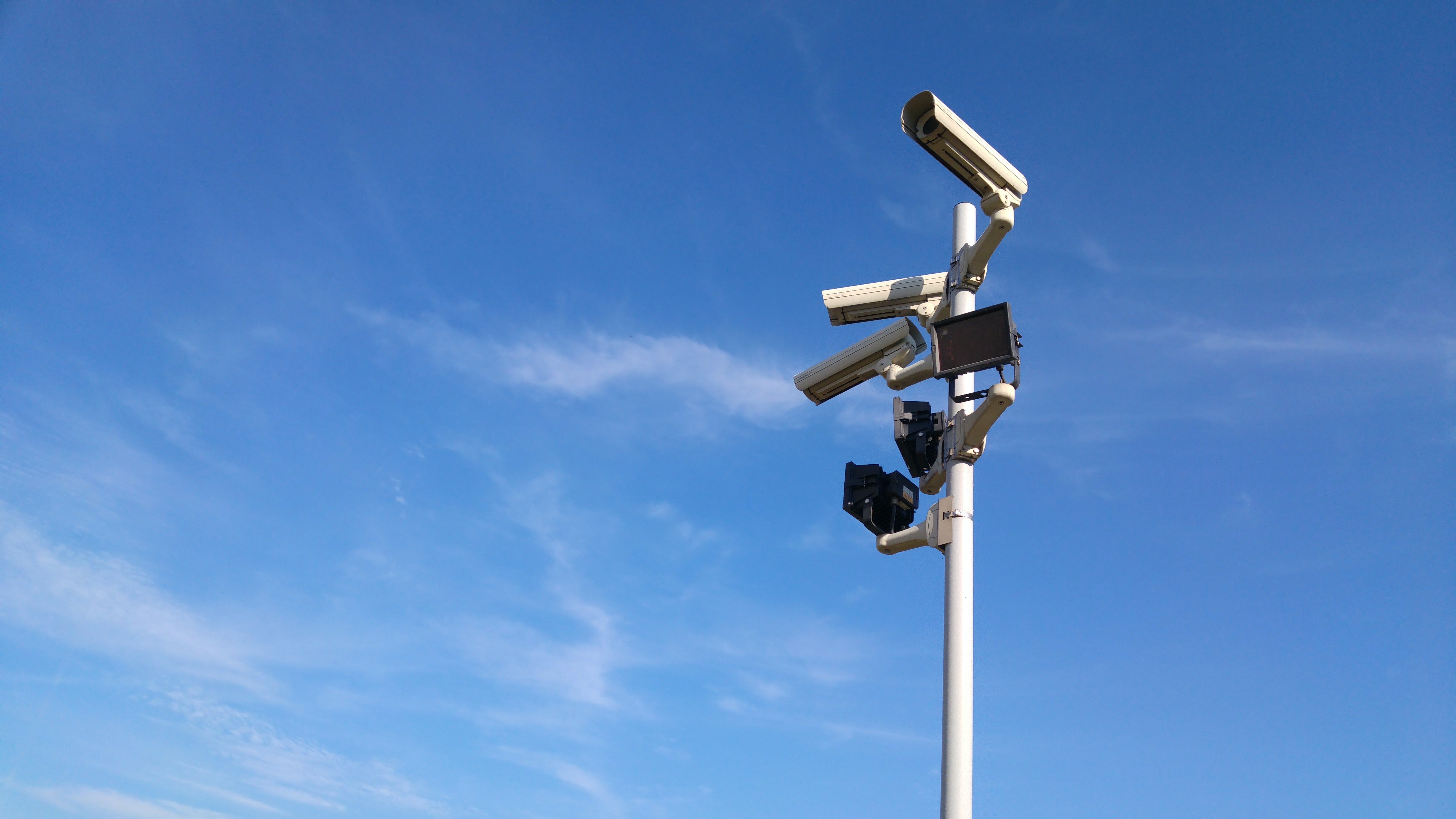 The importance of security for corporate social responsibility in self-storage, shown by a CCTV camera and keypad.